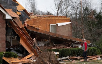 Braden McCann uses his phone and surveys the damage as he stands outside his home along Murrell Rd. After overnight storms that ripped through the community Saturday, Dec. 11, 2021 in Dickson Co., Tenn.  Nas Dec 11 Storm 014 (Photo by George Walker IV / The Tennessean / USA Today Network / Sipa USA)