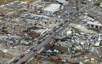 epa09637507 An aerial photo made with a drone shows widespread destruction of homes and businesses after tornadoes moved through the area leaving destruction and death across six states, in Mayfield, Kentucky, USA, 11 December 2021. According to early reports as many as 75 to 100 people lost their lives in Kentucky with more dead in Arkansas in the storms on 10 December.  EPA/TANNEN MAURY