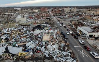 epa09637516 An aerial photo made with a drone shows widespread destruction of homes and businesses after tornadoes moved through the area leaving destruction and death across six states, in Mayfield, Kentucky, USA, 11 December 2021. According to early reports as many as 75 to 100 people lost their lives in Kentucky with more dead in Arkansas in the storms on 10 December.  EPA/TANNEN MAURY