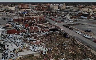 epa09637514 An aerial photo made with a drone shows widespread destruction of homes and businesses after tornadoes moved through the area leaving destruction and death across six states, in Mayfield, Kentucky, USA, 11 December 2021. According to early reports as many as 75 to 100 people lost their lives in Kentucky with more dead in Arkansas in the storms on 10 December.  EPA/TANNEN MAURY