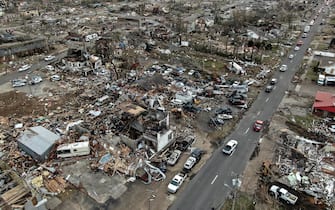 epa09637499 An aerial photo made with a drone shows widespread destruction of homes and businesses after tornadoes moved through the area leaving destruction and death across six states, in Mayfield, Kentucky, USA, 11 December 2021. According to early reports as many as 75 to 100 people lost their lives in Kentucky with more dead in Arkansas in the storms on 10 December.  EPA/TANNEN MAURY