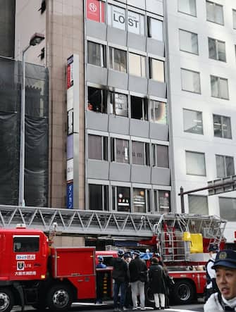 Firefighters in front of the building where the fire occurred in Osaka