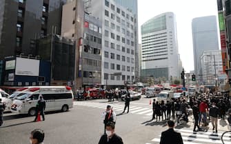 People in front of the Osaka building where the fire occurred