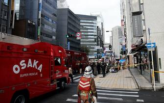 Firefighters in front of the building where the fire occurred in Osaka