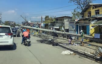 epa09648236 A handout photo made available by the Office of the Vice President (OVP) shows motorists maneuvering next to toppled electric post in the typhoon devastated city of Cebu, Philippines, 18 December 2021. According to the National Disaster Risk Reduction and Management Council (NDRRMC),? the death toll from the strongest typhoon to hit the Philippines this year has risen to 31 and more than 300,000 people were evacuated from their hom?es and beachfront resorts, as Typhoon Rai ravaged the central region of the country.  EPA/HANDOUT  HANDOUT EDITORIAL USE ONLY/NO SALES