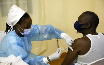 1233138291 A medical worker injects a second dose of Astra Zeneca vaccine to a patient in a Covid-19 (coronavirus) vaccination centre in Kigali, on May 27, 2021. (Photo by Ludovic MARIN / AFP) (Photo by LUDOVIC MARIN/AFP via Getty Images)
