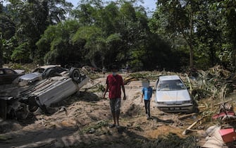 A damaged cars affected by the flood water in Hulu Langat, outside Kuala Lumpur, Malaysia on 20 December, 2021. More than 50,000 people have been forced from their homes in Malaysia and at least seven are dead after the country faced some of its worst floods for years. (Photo by Mat Zain/NurPhoto via Getty Images)