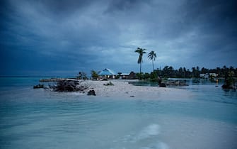 EITA, TARAWA, KIRIBATI - 2015/09/29: The small village Eita has become a separate island during high tide. 

The people of Kiribati are under pressure to relocate due to sea level rise. Each year, the sea level rises by about half an inch. Though this may not sound like much, it is a big deal considering the islands are only a few feet above sea level, which puts them at risk of flooding and sea swells. 

It is well agreeable that the people of Kiribati account for little to nothing in terms of green house emissions but are forced to face the direct consequences of global warming. And with an average age of 22, Kiribati's future generations are at risk of potentially lethal sea level rise. (Photo by Jonas Gratzer/LightRocket via Getty Images)
