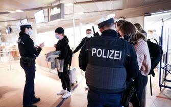 1236829834 25 November 2021, Hamburg: Officers of the Federal Police check the Corona vaccination status and entry registration of arriving passengers on a flight from Amsterdam. Due to the stricter Corona travel rules, travellers must also expect longer waiting times at Hamburg Airport when entering the country. Photo: Christian Charisius/dpa (Photo by Christian Charisius/picture alliance via Getty Images)