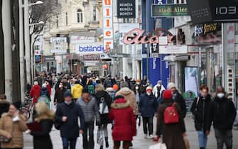VIENNA, AUSTRIA - DECEMBER 13: People are seen at streets as workplaces, shopping and personal care centers reopened after the 20-day of closure, within the new type of coronavirus (COVID-19) restrictions, in Austria. in Vienna, Austria on December 13, 2021. (Photo by Askin Kiyagan/Anadolu Agency via Getty Images)
