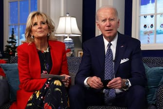 WASHINGTON, DC - DECEMBER 24:  U.S. President Joe Biden and first lady Dr. Jill Biden participate in an event to call NORAD and track the path of Santa Claus on Christmas Eve in the South Court Auditorium of the Eisenhower Executive Building on December 24, 2021 in Washington, DC. The president and first lady also called to speak to Americans and thank military families. (Photo by Alex Wong/Getty Images)