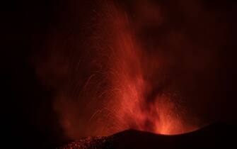 1237202778 The Cumbre Vieja volcano, pictured from El Paso, spews lava on the Canary island of La Palma, Spain on December 13, 2021. - The Cumbre Vieja volcano has been erupting since September 19, forcing more than 6,000 people out of their homes as the lava burnt its way across huge swathes of land on the western side of La Palma. (Photo by PIERRE-PHILIPPE MARCOU / AFP) (Photo by PIERRE-PHILIPPE MARCOU/AFP via Getty Images)