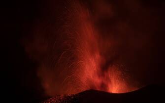 The Cumbre Vieja volcano, pictured from El Paso, spews lava on the Canary island of La Palma, Spain on December 13, 2021. - The Cumbre Vieja volcano has been erupting since September 19, forcing more than 6,000 people out of their homes as the lava burnt its way across huge swathes of land on the western side of La Palma. (Photo by PIERRE-PHILIPPE MARCOU / AFP) (Photo by PIERRE-PHILIPPE MARCOU/AFP via Getty Images)