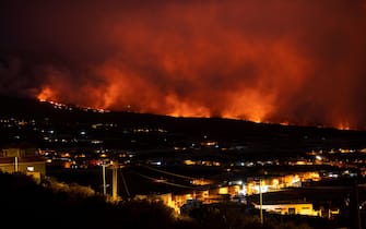 The Cumbre Vieja volcano, pictured from Los Llanos de Aridane, spews lava on the Canary island of La Palma on December 11, 2021. - The Cumbre Vieja volcano has been erupting since September 19, forcing more than 6,000 people out of their homes as the lava burnt its way across huge swathes of land on the western side of La Palma. (Photo by PIERRE-PHILIPPE MARCOU / AFP) (Photo by PIERRE-PHILIPPE MARCOU/AFP via Getty Images)