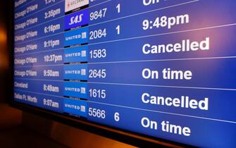epa09656220 Cancelled United Airlines flights to Chicago O'Hare and Cleveland on the flight information display system at the San Francisco International Airport on Christmas Eve in San Francisco, California, USA, 24 December 2021. Thousand of flights were cancelled globally and United and and Delta Airlines cancelled over 200 flights domestically on Friday, 24 December, alone citing the personnel shortages due to the surge of Omicron variant of COVID-19 infections.  EPA/JOHN G. MABANGLO