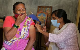 epa09658645 A woman receives a shot of a vaccine against COVID-19 during a free vaccination drive at Public Health Care Center in Bangalore, India, 28 December 2021. The Karnataka government imposed a night curfew for 10 days, starting from 28 December and announced certain fresh restrictions ahead of New Year, amid rising Omicorn variant cases in Karnataka. India reported at least 650 confirmed cases of Omicron variant so far.  EPA/JAGADEESH NV