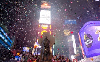 epa09662162 Confetti falls in Times Square during New Year's Day celebrations in New York, New York, USA, 01 January 2022.  EPA/SARAH YENESEL