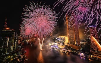 New Years Eve fireworks erupt over the Chao Praya River in Bangkok on December 31, 2021. (Photo by Lillian SUWANRUMPHA / AFP) (Photo by LILLIAN SUWANRUMPHA/AFP via Getty Images)