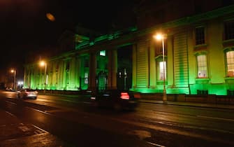epa09077167 Irish government buildings in Dublin, Ireland, 15 March 2021 are lit up green for the Saint Patrick's festival. For the second year running the festival will not take place due to COVID-19 restrictions. Saint Patrick's day is celebrated on 17 March. Ireland has temporaily postponed using the Astra-Zenica vaccine due to health concerns which has slowed down the pace of vaccination.  EPA/Aidan Crawley