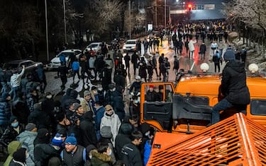 Protesters attend a rally in Almaty on January 4, 2022, after energy price hikes. - Police fired tear gas and stun grenades in a bid to break up an unprecedented thousands-strong march in Almaty, Kazakhstan's largest city, after protests that began over fuel prices threatened to spiral out of control. (Photo by Abduaziz MADYAROV / AFP) (Photo by ABDUAZIZ MADYAROV/AFP via Getty Images)