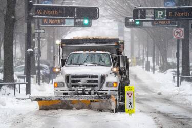 GREENVILLE, SC - JANUARY 16: A snow plow clears Main St. on January 16, 2022 in Greenville, South Carolina. The winter storm brought snow, sleet and freezing rain to parts of the Carolinas and Georgia, where nearly 300,000 were left without power. (Photo by Sean Rayford/Getty Images)