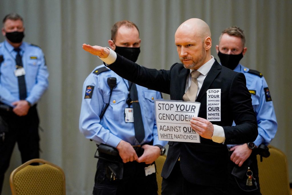 Anders Behring Breivik raises his arm to make a Nazi salute as he arrives on the first day of the trial where he is requesting release on parole, on January 18, 2022 at a makeshift courtroom in Skien prison, Norway. - The mass murderer Anders Behring Breivik, who now calls himself Fjotolf Hansen, was in 2012 sentenced to a at least 21 years inprisonment. Under Norwegian law, Breivik is entitled to a review in court after the initial term of 10 years. 77 people lost their lives in the attacks that took place in Oslo and UtÃ¸ya (Utoya) on July 22, 2011. - Norway OUT (Photo by Ole Berg-Rusten / NTB / AFP) / Norway OUT (Photo by OLE BERG-RUSTEN/NTB/AFP via Getty Images)