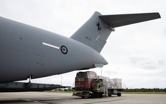 NUKU'ALOFA, TONGA - JANUARY 20: In this handout image provided by the Australian Defence Force, Australian Defence Force members load humanitarian aid supplies onto a Royal Australian Air Force C-17A Globemaster III aircraft at RAAF Base Amberley on January 20, 2022 in Nuku'alofa, Tonga. The undersea Hunga Tonga-Hunga Ha'apai volcano near Tonga erupted on Saturday 15 January, causing a subsequent tsunami in the nearby Tongan capital of Nuku'alofa and surrounding islands as well as triggering tsunami warnings across the Pacific region. (Photo by LACW Kate Czerny/Australian Defence Force via Getty Images)