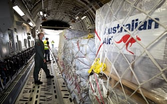 NUKU'ALOFA, TONGA - JANUARY 20: In this handout image provided by the Australian Defence Force, Air Force Load Master Corporal Dale Hall inspects humanitarian aid supplies aboard a Royal Australian Air Force C-17A Globemaster III aircraft at RAAF Base Amberley on January 20, 2022 in Nuku'alofa, Tonga. The undersea Hunga Tonga-Hunga Ha'apai volcano near Tonga erupted on Saturday 15 January, causing a subsequent tsunami in the nearby Tongan capital of Nuku'alofa and surrounding islands as well as triggering tsunami warnings across the Pacific region. (Photo by LACW Kate Czerny/Australian Defence Force via Getty Images)