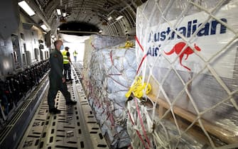 NUKU'ALOFA, TONGA - JANUARY 20: In this handout image provided by the Australian Defence Force, Air Force Load Master Corporal Dale Hall inspects humanitarian aid supplies aboard a Royal Australian Air Force C-17A Globemaster III aircraft at RAAF Base Amberley on January 20, 2022 in Nuku'alofa, Tonga. The undersea Hunga Tonga-Hunga Ha'apai volcano near Tonga erupted on Saturday 15 January, causing a subsequent tsunami in the nearby Tongan capital of Nuku'alofa and surrounding islands as well as triggering tsunami warnings across the Pacific region. (Photo by LACW Kate Czerny/Australian Defence Force via Getty Images)