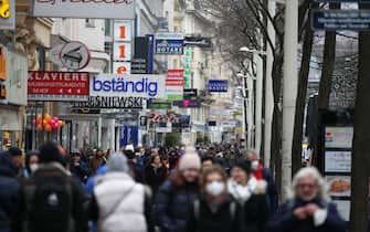 VIENNA, AUSTRIA - DECEMBER 13: People are seen at streets as workplaces, shopping and personal care centers reopened after the 20-day of closure, within the new type of coronavirus (COVID-19) restrictions, in Austria. in Vienna, Austria on December 13, 2021. (Photo by Askin Kiyagan/Anadolu Agency via Getty Images)