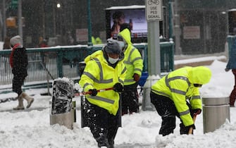 epa09716901 Workers shovel snow in Columbus Circle in New York, New York, USA, 29 January 2022. The large storm is hitting a substantial portion of the East Coast of the United States, disrupting travel and some areas are forecast to receive up to 2 feet (61 centimeters) of snow.  EPA/Peter Foley