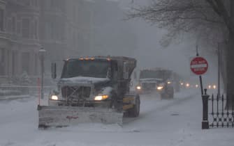 epa09716642 Snow plows make their way down Commonwealth Avenue, in Boston, Massachusetts, USA, 29 January 2022. A winter storm is expected to bring up to 40in (102cm) of snow to the east coast areas of Massachusetts, along with extreme high tides and flooding.  EPA/CJ GUNTHER