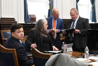KENOSHA, WISCONSIN - NOVEMBER 05:  KYLE RITTENHOUSE looks on as defense attorneys NATALIE WISCO and COREY CHIRAFISI look at exhibits before court with Assistant District Attorney JAMES KRAUS right during the trial of Kyle Rittenhouse  on November 5, 2021 in Kenosha, Wisconsin. Rittenhouse is accused of shooting three demonstrators, killing two of them, during a night of unrest that erupted in Kenosha after a police officer shot Jacob Blake seven times in the back while being arrested in August 2020. Rittenhouse, from Antioch, Illinois, was 17 at the time of the shooting and armed with an assault rifle. He faces counts of felony homicide and felony attempted homicide. (Photo by Mark Hertzberg-Pool/Getty Images)