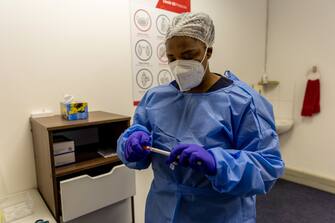 A health worker prepares a coronavirus swab test at a Testaro Covid-19 testing site in the Goodwood district of Cape Town, South Africa, on Thursday, Dec. 2, 2021. South Africa announced the discovery of a new variant, later christened omicron, on Nov. 25 as cases began to spike and the strain spread across the globe. Photographer: Dwayne Senior/Bloomberg via Getty Images