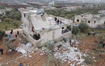 epa09724582 An aerial picture taken by a drone shows people inspecting a damaged building after an alleged counterterrorism operation by US Special forces in the early morning in Atma village in the northern countryside of Idlib, Syria, 03 February 2022. Pentagon Press Secretary John Kirby said that 'U.S. Special Operations forces under the control of U.S. Central Command conducted a counterterrorism mission in northwest Syria'. The Britain-based Syrian Observatory for Human Rights reported that there were 'confirmed reports of fatalities', but did not provide numbers or identities.  EPA/YAHYA NEMAH