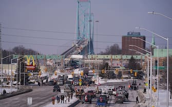 Anti vaccine mandate protestors block the roadway leaving the Ambassador Bridge border crossing, in Windsor, Ontario, Canada on February 8, 2022. - The protestors who are in support of the Truckers Convoy in Ottawa blocked traffic in the Canada bound lanes since Monday evening. Approximately $323 million worth of goods cross the Windsor-Detroit border each day at the Ambassador Bridge making it North Americas busiest international border crossing. (Photo by Geoff Robins / AFP) (Photo by GEOFF ROBINS/AFP via Getty Images)