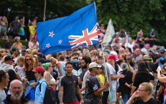 1369676936 WELLINGTON, NEW ZEALAND - FEBRUARY 10: A New Zealand flag is flown upside-down during a protest at Parliament on February 10, 2022 in Wellington, New Zealand. Anti-vaccine and Covid-19 mandate protesters were broken up by police after three days of demonstrations outside Parliament. (Photo by Hagen Hopkins/Getty Images)