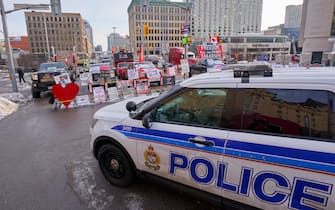 epa09741743 Police blocks the road as the truckers continue to protest the vaccine mandates in in downtown Ottawa, Ontario, Canada, 09 February 2022. Since 29 January 2022, truckers are protesting against the mandate by the Canadian government that truckers be vaccinated against COVID-19 to return to Canada, and was joined by other opponents of the Canadian Prime Minister. A state of emergency was declared in the city of Ottawa on 06 February 2022 and policemen from Ottawa city, Ontario, and the Federal Royal Canadian Mounted Police (RCMP) are deployed.  EPA/ANDRE PICHETTE