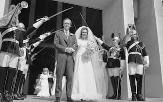 Camilla Shand and Major Andrew Parker-Bowles pass through the Guard of Honour after their wedding at the Guards Chapel, Wellington Barracks, 4th July 1973. (Photo by Wood/Express/Hulton Archive/Getty Images)