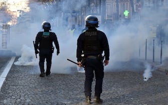 PARIS, FRANCE - FEBRUARY 12: French Police use teargas to disperse members of Freedom Convoy on Champs Elysees Avenue in Paris, France on February 12, 2022. (Photo by Yusuf Ozcan/Anadolu Agency via Getty Images)