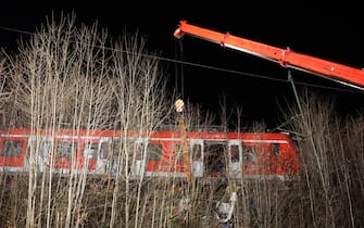 14 February 2022, Bavaria, Schäftlarn: A crane is in use at the scene of the accident. One person was killed and more than ten injured in a collision between two commuter trains in the Munich district on Monday. There was a low double-digit number of injured, reported a spokesman for the Munich police headquarters. Photo: Matthias Balk/dpa (Photo by Matthias Balk/picture alliance via Getty Images)