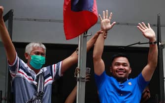 epa09760973 Filipino Senator and boxing icon Manny Pacquiao (R), a presidential contender in the May 2022 national elections, gestures during a campaign rally in Manila, Philippines, 16 February 2022. Pacquiao announced his retirement from the sport of boxing and has set to fight for president in the May 2022 national elections against popular contender Ferdinand 'Bongbong' Marcos Junior, son of former strongman Ferdinand Marcos.  EPA/FRANCIS R. MALASIG