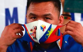 epa09760955 Filipino Senator and boxing icon Manny Pacquiao, a presidential contender in the May 2022 national elections, wears a face mask during a campaign rally in Manila, Philippines, 16 February 2022. Pacquiao announced his retirement from the sport of boxing and has set to fight for president in the May 2022 national elections against popular contender Ferdinand 'Bongbong' Marcos Junior, son of former strongman Ferdinand Marcos.  EPA/FRANCIS R. MALASIG