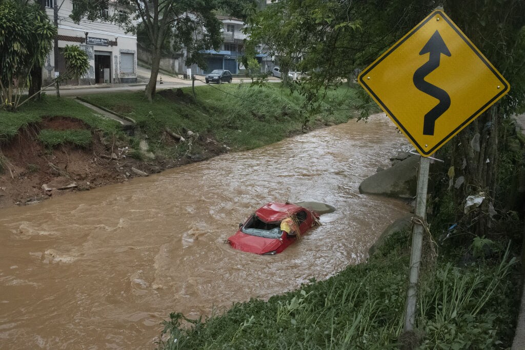 RIO DE JANEIRO, BRAZIL Ã¢FEBRUARY 16: A vehicle is seen in a stream after heavy rains hit Petropolis, Rio de Janeiro, Brazil on February 16, 2022. At least 67 have been killed after heavy rains hit Petropolis in the Brazilian state of Rio de Janeiro. Fifty-four houses were destroyed and 370 people are being housed in shelters. Also, 400 firefighters are participating in search and rescue efforts in the region but authorities have not yet determined the number of missing people. (Photo by Fabio Teixeira/Anadolu Agency via Getty Images)
