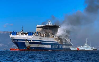 Firefighting vessels work to estinguish a fire onboard the Italian-flagged ferry Euroferry Olympia, off the Greek Ionian island of Corfu on February 19, 2022. - Rescuers picked up the search for 12 missing people at the break of dawn on February 19, with the ship of Italian company Grimaldi still burning on the Ionian Sea off Corfu. The blaze on the Euroferry Olympia prevented rescuers from boarding in the morning of February 19, but a helicopter, a frigate, a fire-fighting vessel and six tug boats were operating in the area more than 50 kilometres (30 miles) from Corfu. (Photo by Voula Pappa/In time news / IN TIME NEWS / AFP) (Photo by VOULA PAPPA/IN TIME NEWS/IN TIME NEWS/AFP via Getty Images)