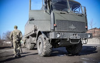 A Ukrainian Military Forces serviceman walks past a military vehicle in the Donetsk region town of Avdiivka, on the eastern Ukraine front-line with Russia-backed separatists on February 21, 2022. - The rebel leaders of east Ukraine's two self-proclaimed republics asked Russian President to recognise the independence of their breakaway territories in a coordinated appeal on February 21. (Photo by Aleksey Filippov / AFP) (Photo by ALEKSEY FILIPPOV/AFP via Getty Images)