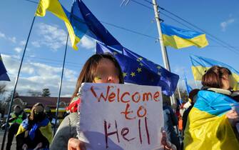 A Ukrainian protester seen holding a placard expressing her opinion during the rally called 