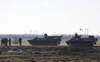 epa04632488 Ukrainian servicemen drive on Armored Personnel Carriers with 'Murka' (L) and 'Boa' and 'Komet' (R) at the checkpoint near village Roty, not far from the eastern Ukrainian city of Debaltseve, Donetsk area, 22 February 2015. A blast in the eastern Ukrainian city of Kharkiv has killed two people during a march to mark the one year anniversary of the ouster of president Viktor Yanukovych, the Interior Ministry said.  One of the dead was a police officer guarding the event.  At least 15 others were injured in the blast, which occurred around 1:20 pm (1120 GMT), the ministry said in a statement.  EPA / ANASTASIA VLASOVA