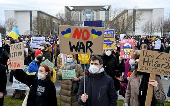 TOPSHOT - People protest against Russia's invasion of Ukraine on February 24, 2022 in front of the Chancellery in Berlin. (Photo by John MACDOUGALL / AFP) (Photo by JOHN MACDOUGALL/AFP via Getty Images)