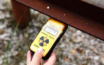 A tourist measures radiation in the abandoned city of Pryryat in the Chernobyl exclusion zone in Ukraine on June 7, 2019. The US HBO’s hugely popular television series 'Chernobyl' has renewed interest around the world on Ukraine’s 1986 nuclear disaster with authorities reporting a 30% increase of tourist demands to visit the affected area and tourist operators forecasting that number of tourists visiting the site may double this year up to 150.000 persons. The success of a US television miniseries examining the world's worst nuclear accident has driven up the number of tourists wanting to see the plant and the ghostly abandoned town of Prypyat as local media reported. 
 (Photo by Alex Chitaro/Sipa USA)